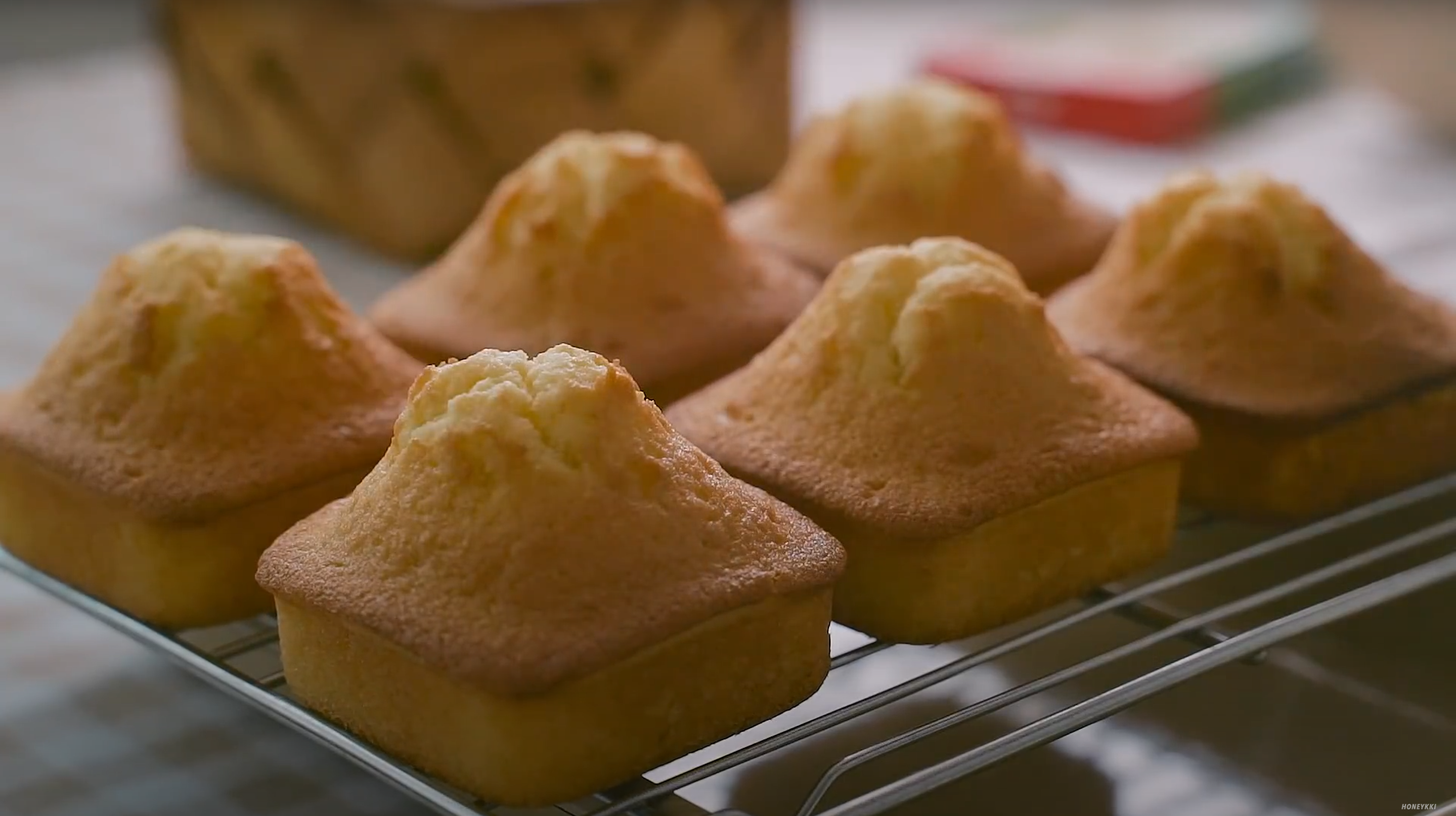 image of mini pound cakes out of the oven on a cooling rack